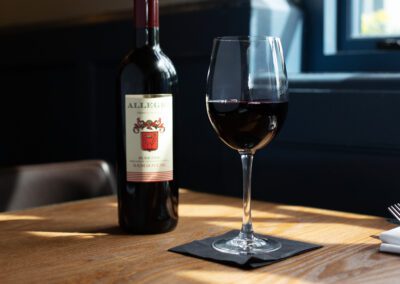Picture of Allegre red wine bottle next to a wine glass
