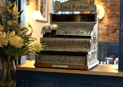 Vintage cash register next to flower bouquet